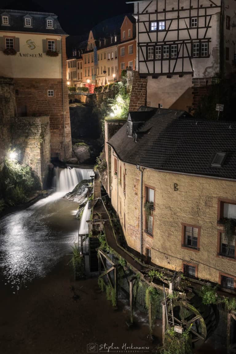 Wasserlauf und Mühlrad in der Altstadt von Saarburg bei Nacht